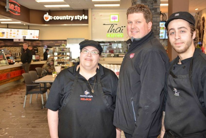 Granville Street Mel's opened Monday in Summerside. It was a busy day for Laurie LeBlanc, left, manager of Mr. Sub and Country Style, site manager Ryan Simmonds, and Julian Rogers, manager of Thai Express.