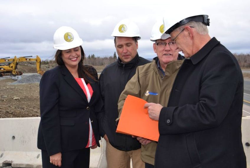 Membertou executive business development officer Jennifer Deleskie, from left, CFO Mike McIntyre, Chief Terry Paul and executive business development officer Bill Bonnar review some of the plans for development during a visit Tuesday to the site of a new overpass currently under construction. The growing Mi’kmaq community is expanding to the south side if Highway 125, with plans for residential and commercial development.