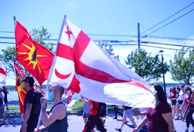 Mi'kmaq Grand Council flag and the Warrior flags proudly displayed during the walk for Justice.