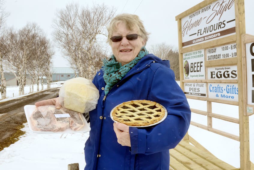 Beatrice Doiron holds up homemade bread, a blueberry pie and “grass fed to grass-finished” steaks purchased from Hunter River Home-Style Flavours on Rennies Road. Doiron and her husband previously owned the farm, which was purchased by Ontario Mennonites Samuel and Ellen Bowman last year. Doiron has stayed in touch with the couple and is a regular customer of their store. MITCH MACDONALD/THE GUARDIAN
