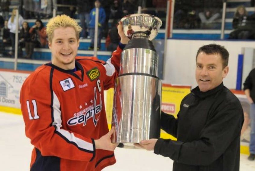 Derryl Smith is pictured here presenting the Kent Cup to Summerside Western Capitals forward and captain Harrison McIver in this file photo.