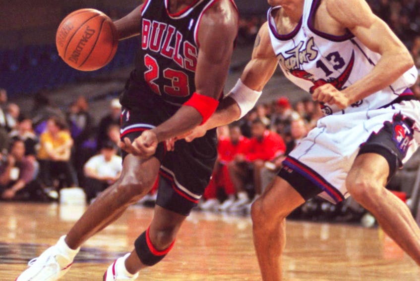 Bulls’ Michael Jordan drives on the Raptors’ Doug Christie. 