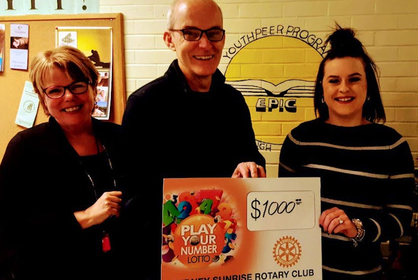 EPIC director Delores Feltmate and volunteer director Kelsey MacNeil accept a cheque from Play Your Number Lottery chair Lorne Baldin. CONTRIBUTED