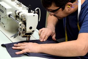 A Michelin employee in the Annapolis Valley works with a pattern for a pair of scrubs destined for the nearby Valley Regional Hospital in Kentville. Contributed