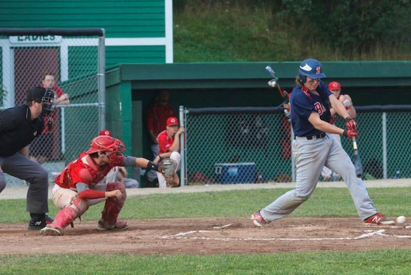 Corner Brook Barons’ batter Dawson Drake gets a piece of a pitch from St. John’s Capitals starter Ryan Morgan (not shown) during the final of the Pepsi provincial midget AA baseball championship at St. Pat’s Ball Park in St. John’s on Sunday. John Cribb is the Capitals’ catcher. St. John’s won 11-0.