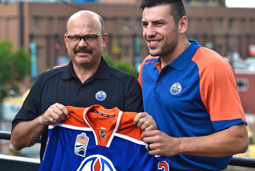 Oilers forward Milan Lucic and GM Peter Chiarelli before talking to the media in Edmonton, Friday, July 1, 2016. 