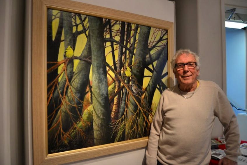 <br /><br />Artist Robert Milner with his painting, "In the Trees." 