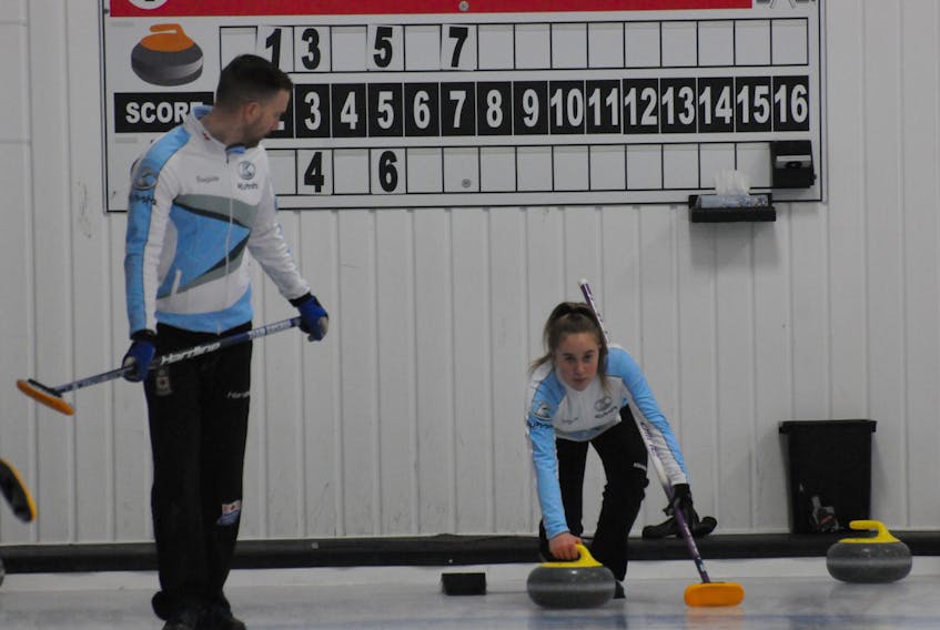 Brad Gushue gets ready to sweep a shot by his daughter Hayley during their first game in the provincial mixed doubles curling championship Wednesday at the Re/Max Centre in St. John’s. — Joe Gibbons/The Telegram
