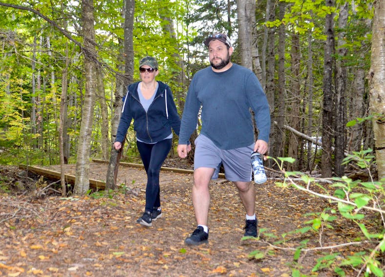 Falling leaves and changing colours made for a great exploration of Coxheath trail for Andrew and Shauna Guiggey on Friday. Tourism operators are hoping fall foliage viewing and other fall vacation packages can assist a trouble tourism sector. GREG MCNEIL/CAPE BRETON POST