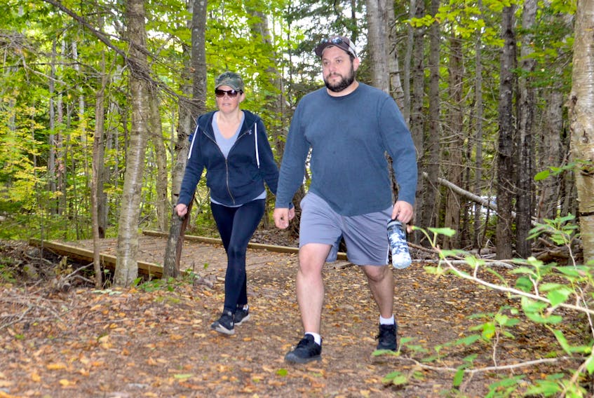 Falling leaves and changing colours made for a great exploration of Coxheath trail for Andrew and Shauna Guiggey on Friday. Tourism operators are hoping fall foliage viewing and other fall vacation packages can assist a trouble tourism sector. GREG MCNEIL/CAPE BRETON POST
