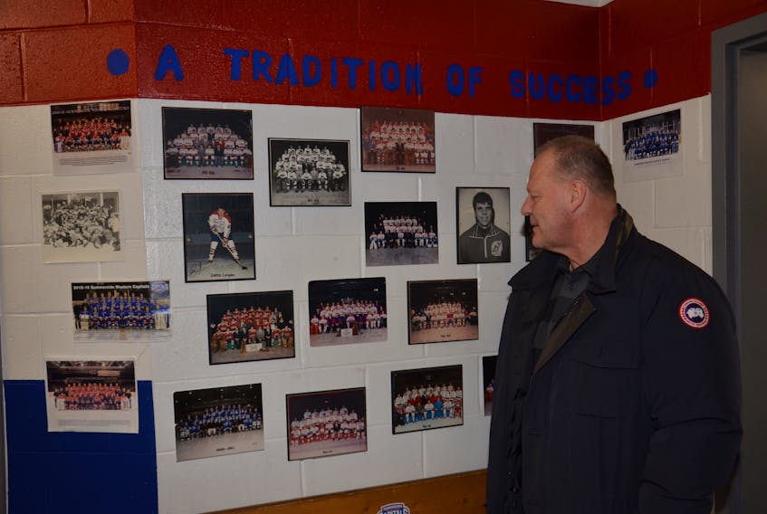 Gerard (Turk) Gallant checks out alumni photos inside the Summerside Western Capitals’ dressing room on Saturday night. Gallant, who was fired by the Vegas Golden Knights on Wednesday, was back in his hometown and attended the Caps’ 8-1 victory over the Fredericton Red Wings in the Maritime Junior Hockey League.