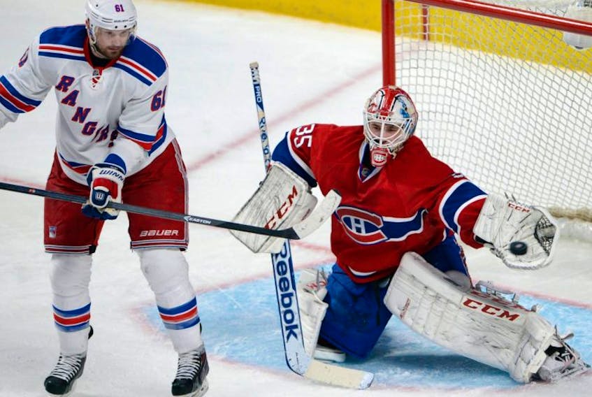 Montreal Canadiens goalie Dustin Tokarski (35) makes a glove save on New York Rangers left wing Rick Nash (61) during third period in game five of the NHL Eastern Conference final Stanley Cup playoff action May 27, 2014 in Montreal.