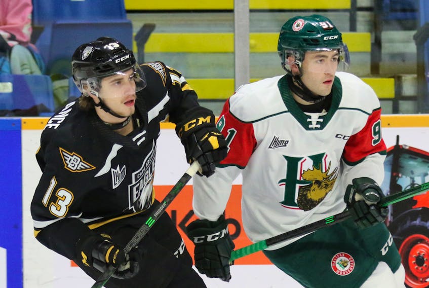 Felix Lafrance of the Cape Breton Eagles and Elliot Desnoyers of the Halifax Mooseheads track the play during Saturday's QMJHL game at Centre 200 in Sydney. (CONTRIBUTED/MIKE SULLIVAN)