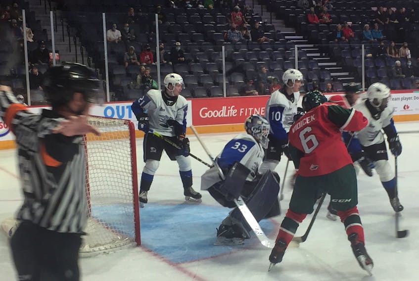 A Halifax shot glances off the post by Saint John Sea Dogs goalie Creed Jones as Mooseheads forward Markus Vidicek looks on during QMJHL play Saturday evening at Scotiabank Centre. The Mooseheads were victorious 5-4 in a shootout.  GLENN MacDONALD