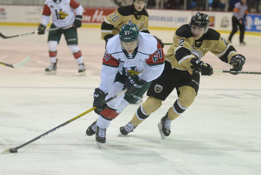 Halifax Mooseheads centre Sonny Kabatay, left, protects the puck from Charlottetown Islanders defenceman Will Trudeau during a Quebec Major Junior Hockey League game at the Eastlink Centre in Charlottetown on Sunday. (JASON MALLOY/Charlottetown Guardian)
