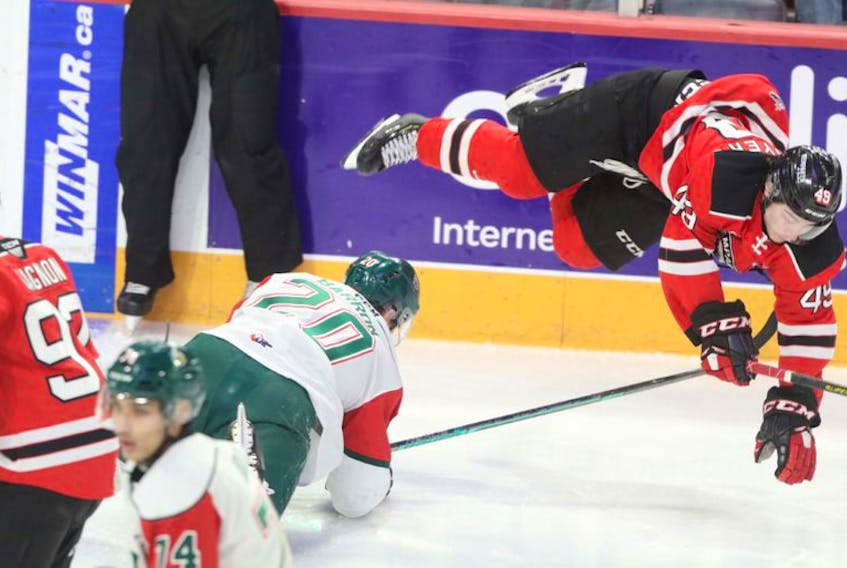 Halifax Mooseheads defenceman Justin Barron trips up Quebec Remparts forward Edouard Cournoyer early in the first period of Friday's QMJHL game at the Scotiabank Centre. (ERIC WYNNE/Chronicle Herald)