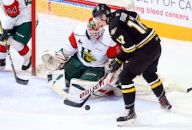Cape Breton Screaming Eagles’ Cole Fraser tries to get control of the puck in front of Halifax Mooseheads goaltender Alex Gravel midway through the first period of Saturday's QMJHL game at the Scotiabank Centre. (ERIC WYNNE/Chronicle Herald)