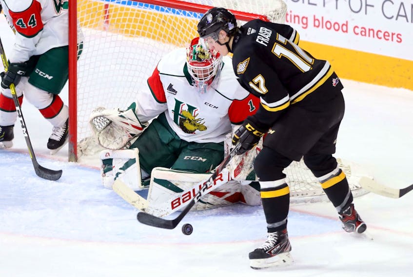 Cape Breton Screaming Eagles’ Cole Fraser tries to get control of the puck in front of Halifax Mooseheads goaltender Alex Gravel midway through the first period of Saturday's QMJHL game at the Scotiabank Centre. (ERIC WYNNE/Chronicle Herald)