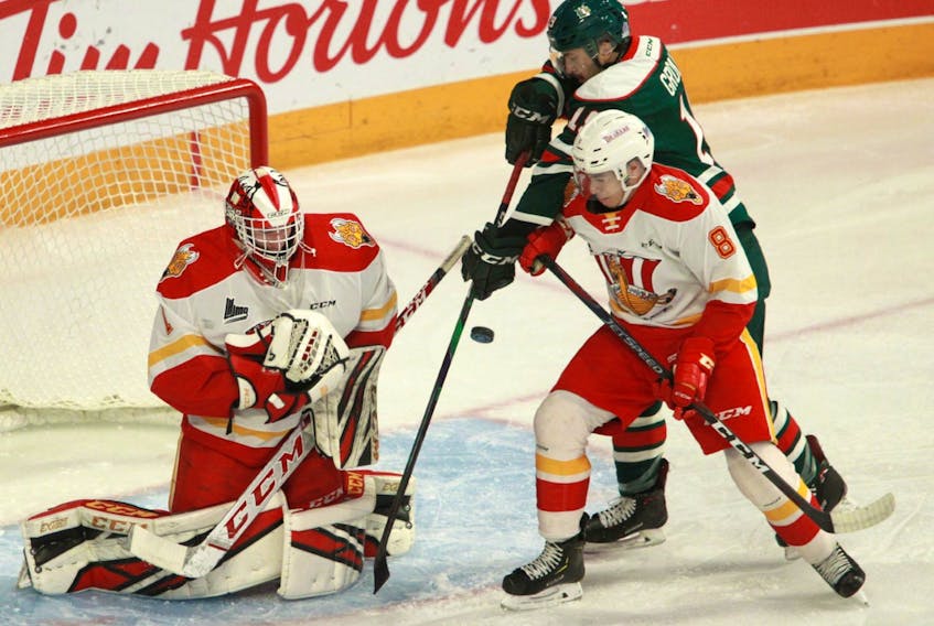 Halifax Mooseheads centre Benoit-Olivier Groulx, top, tries to deflect a shot from the point between Baie-Comeau Drakkar goalie Lucas Fitzpatrick and defenceman Christopher Merisier-Ortiz during QMJHL action at the Scotiabank Centre on Thursday. (TIM KROCHAK/Chronicle Herald)
