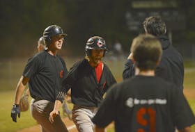 Taylor Larkin, second from left, celebrates with his Morell Chevies’ teammates after scoring the winning run in the bottom of the seventh inning Tuesday at Memorial Field. The Chevies won Game 1 of their best-of-five Kings County Baseball League semifinal 8-7 over the Peakes Tee Bombers.