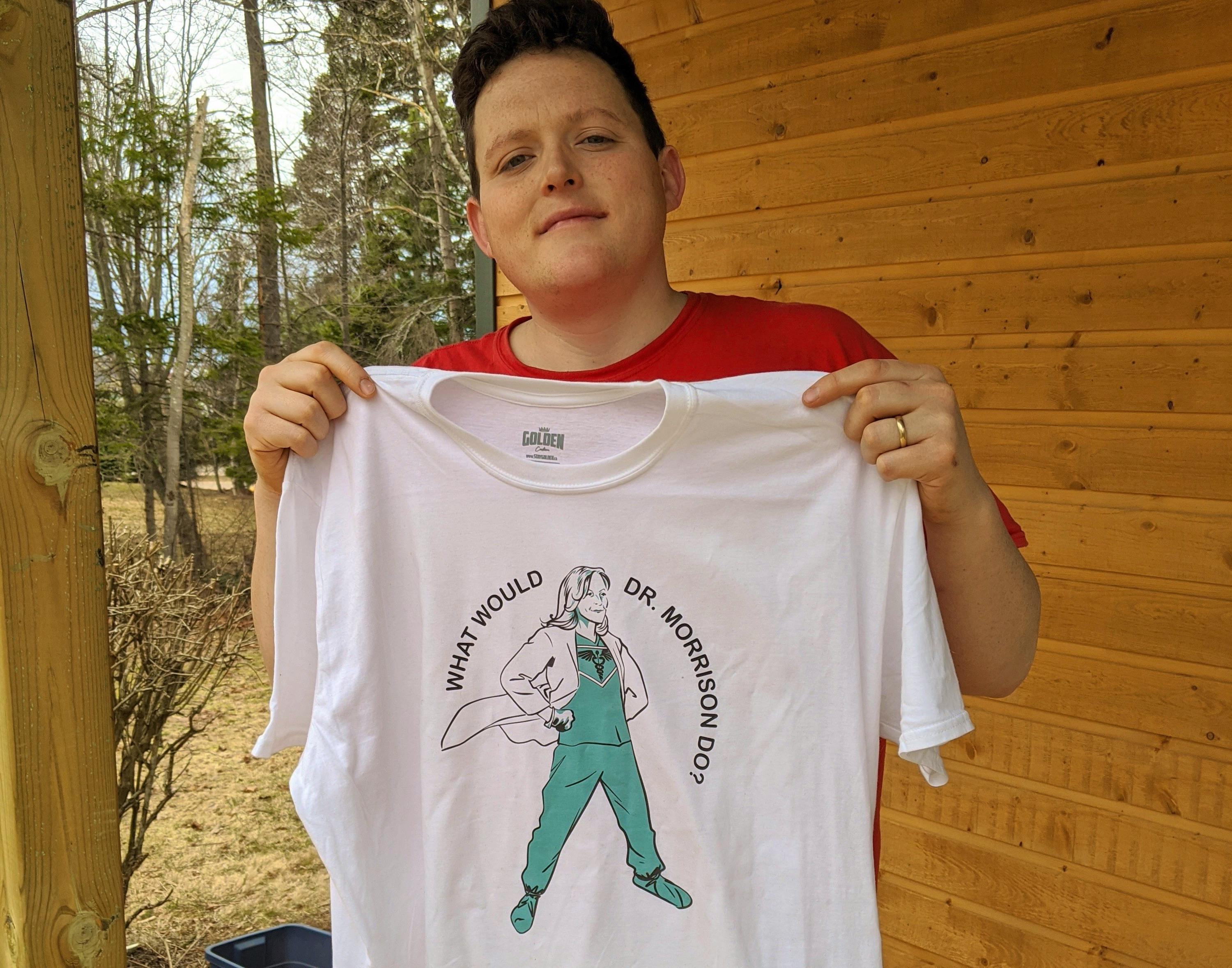 Mikey Wasnidge, co-owner of the Nimrods’ restaurant in Charlottetown, holds up the T-shirt that he and his business partners created as a tribute to Dr. Heather Morrison, P.E.I.’s chief pubic health officer. The T-shirts will be on sale for the next two weeks at https://nimrods.staygolden.ca/ with $10 from each sale going to the United Way of P.E.I. 