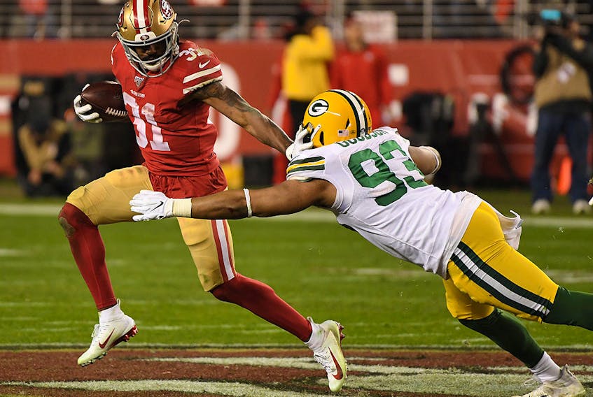Raheem Mostert of the San Francisco 49ers stiff arms B.J. Goodson of the Green Bay Packers during the second half of the NFC Championship game at Levi's Stadium on Jan. 19, 2020 in Santa Clara, Calif.