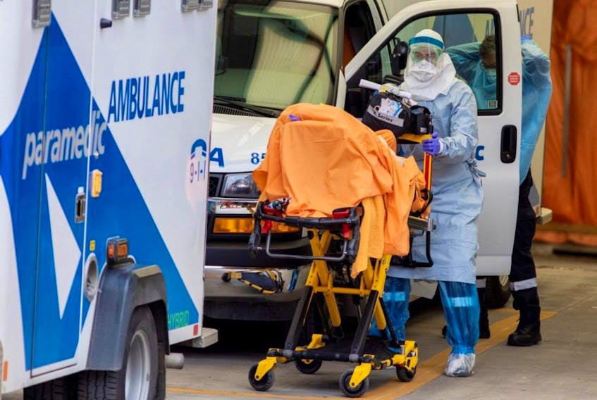 A paramedic transports a patient to Mount Sinai Hospital in Toronto, April 17, 2020.