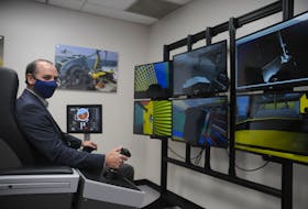 Joe Singleton, assistant head of the Marine Institute's school of ocean technology, sits at one of the new simulators students will use in the underwater exploration laboratory. — Andrew Robinson/The Telegram