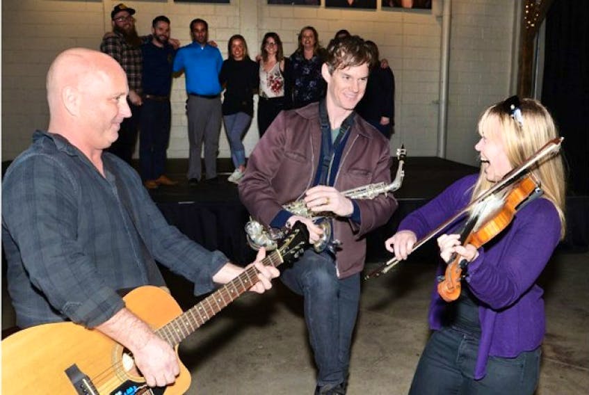 Richie Bulger, left, Todd MacLean, and Cynthia MacLeod kick it up in preparation for the May 13 fundraiser for Fort McMurray at the P.E.I Brewing Company. Island artists unite for an evening of music, fun and fundraising for the Canadian Red Cross in support of wildfire relief. Tickets can be purchased at the P.E.I. Brewing Company (96 Kensington Road) and Kwik Kopy Printing (91 Euston Street).
