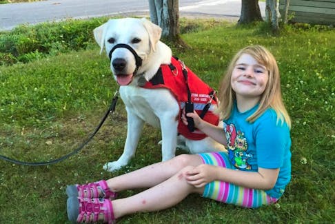<p>Five-year-old Nancy Holloway and her Autism Assistance dog Yuko.</p>