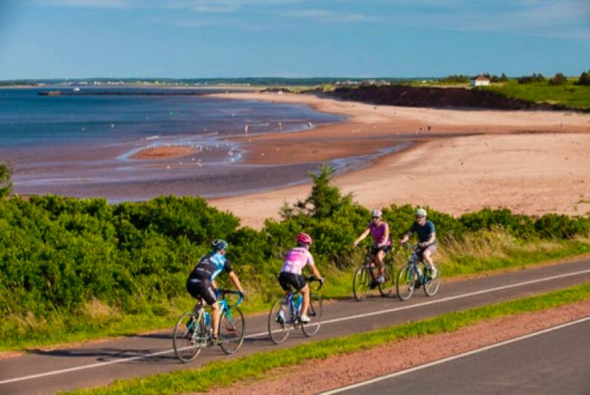Cyclists passing by the National Park beach in Cavendish.