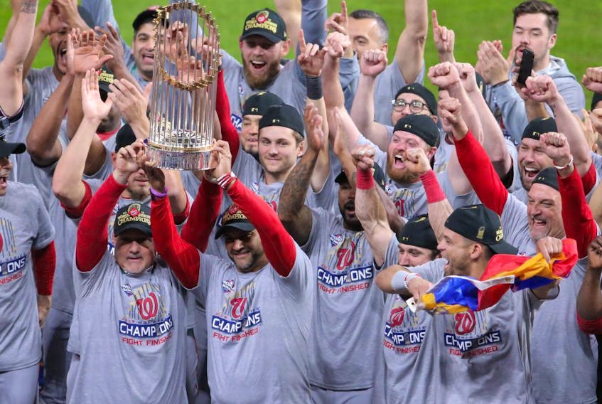 Washington Nationals manager Dave Martinez and his team hoist the Commissioners Trophy after defeating the Houston Astros in Game 7 of the 2019 World Series at Minute Maid Park on Oct. 30, 2019. The Washington Nationals won the World Series winning four games to three.