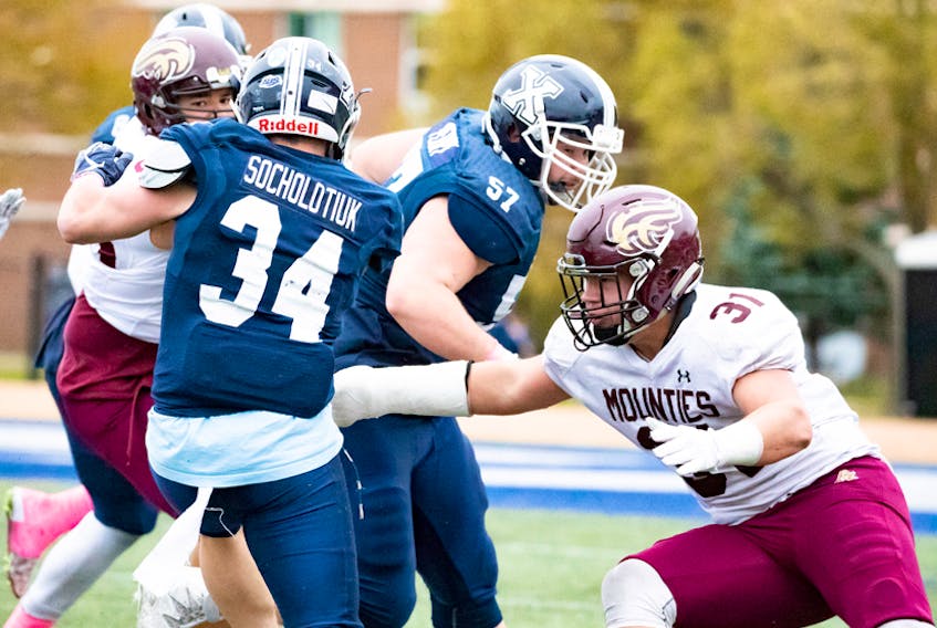 Fourth-year Mountie Dylan Cormier, shown above (#31) about to wrap up an opposing player during the 2018 season, says it was “amazing” to finally have his younger brother, rookie Lucas, join him on the field.    PAULDLYNCH.COM PHOTO