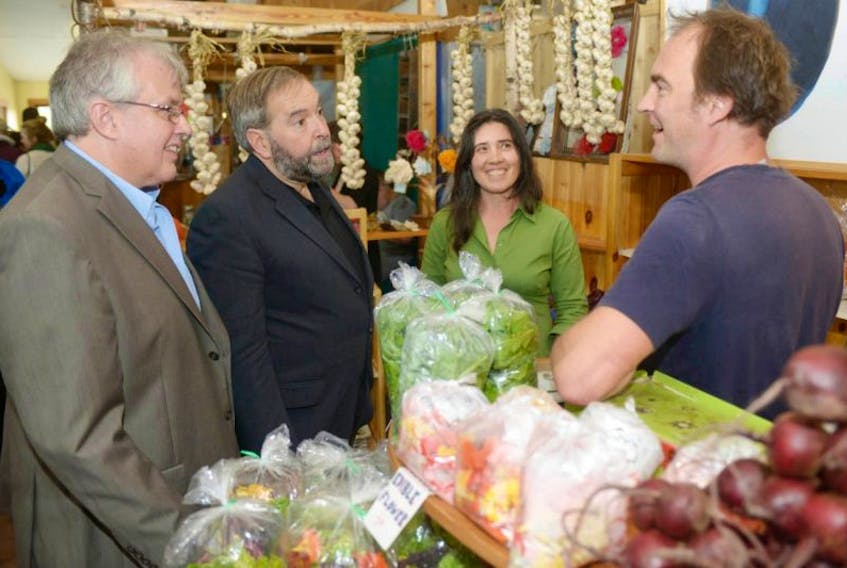 <p>Federal NDP leader Tom Mulcair and &nbsp;Charlottetown candidate Joe Byrne chat with Angel McKann and Hans Wendt at a Charlottetown Farmer’s Market booth on Saturday.</p>
