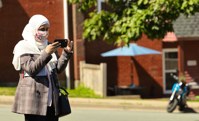 Health-care reporter Nebal Snan covers a news event for The Chronicle Herald in Halifax in August 2020. Her position is funded by the federal government's local journalism initiative program.