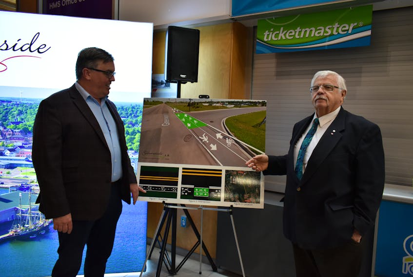 Minister Steven Myers, left, and Summerside Mayor Basil Stewart discuss the city's new active transport path after the announcement was made on Sept. 18