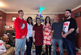 The James family poses for a family photo on Christmas Day in St. Philip's, two days after Chris arrived home from Toronto with a double-lung transplant.  From left are Brandan, mother Kim, Cassie, Candace, father Keith, and Chris.
