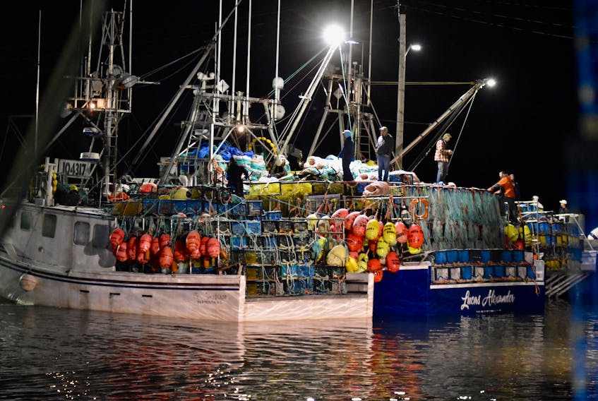 Nova Scotia fishing crews tend to last minute details for the start of the LFA 34 commercial lobster season, Dec. 8. TINA COMEAU PHOTO