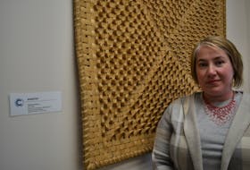 The Cape Breton Centre for Craft and Design in downtown Sydney is looking to diversify its membership with the help of two new hires says executive director Lori Burke, who is standing next to a large piece of traditional Mi'kmaq basketry woven with birch and sweet grass by artist Margaret Johnson. ARDELLE REYNOLDS • SALTWIRE NETWORK