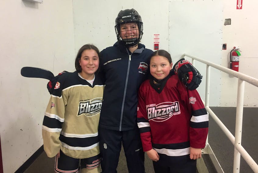Erin Denny, centre, takes a photo with Kassie Cremo (left) and Jersey Dennis at Eskasoni rink on Feb. 2, the first day of the Indigenous Female Hockey Program in the community. The program is a two-year pilot project put on by Hockey Nova Scotia which aims to create opportunities for Indigenous girls in Nova Scotia to learn basic hockey skills. Denny, 17, is a coach for the program in Membertou (Wednesdays) and Eskasoni (Sundays) and Cremo and Dennis are players. CONTRIBUTED 