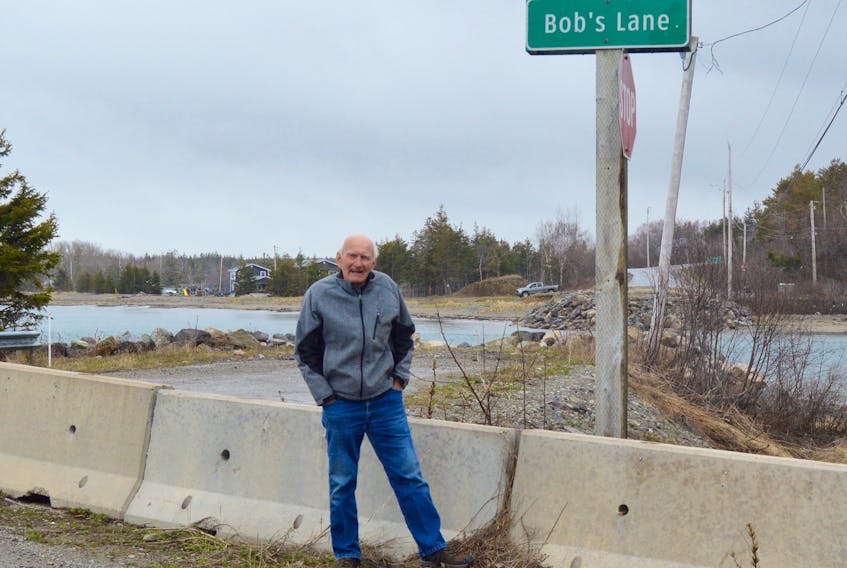 Bob Martell, better known as Bridge Man Bob, stands in front of the barricade that was erected after the old Mira Gut bridge was demolished in 2017. Since then, motorists have had to take an inconvenient 30-minute detour involving using the Albert Bridge located further upriver. Martell spent four decades as the man responsible for opening and closing the old span that was some 140 years old when it was taken down. On Saturday, the province announced the timeline for a new Mira Gut bridge. Construction is expected to begin in the spring of 2021 and be completed by the summer of 2022. The new span will have two lanes and a sidewalk. DAVID JALA/CAPE BRETON POST