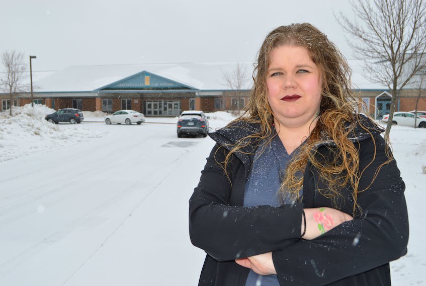 Jennifer Gallant of New Waterford stands out in front of Greenfield Elementary School in River Ryan, upset after she says her seven-year old daughter was recently held down by two boys and choked by another on the school grounds at lunch time. Sharon Montgomery-Dupe/Cape Breton Post