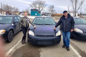 Elizabeth Doyle, left, and Chuck Ogley stand next to some of their District 11 Taxi vehicles.  The couple have decided to start delivering grocery orders for free to people who want to stay home during the COVID-19 outbreak. Contributed/ Chuck Ogley