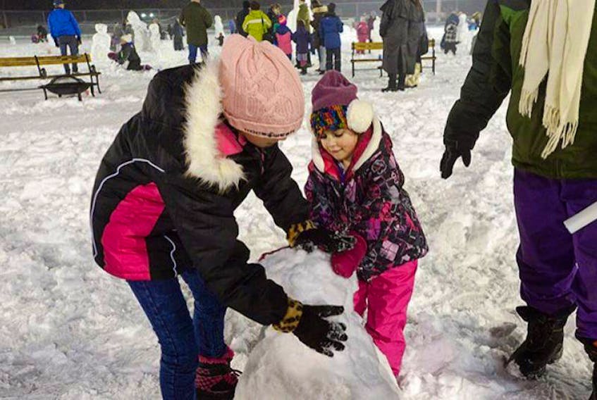 Auiem Ifrach, left, and her sister Hadas try their hand at making their first ever snowman in Victoria Park in Charlottetown during Capital New Year in the Park festivities on Dec. 31, 2015. The family had just immigrated form Israel two months earlier.

(Guardian File Photo/Nigel Armstrong)