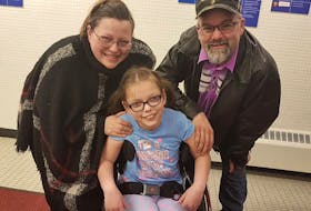 Ten-year-old Claire McDonald poses for a picture with her parents, Jeanine Hannah McDonald and Barry McDonald. — CONTRIBUTED