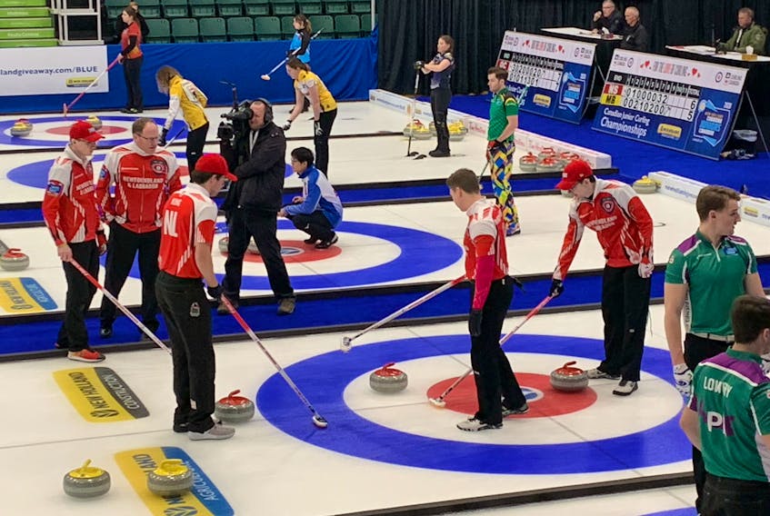 The Daniel Bruce rink (red) discusses strategy during a game at the national junior curling championships in Langley, British Columbia. CONTRIBUTED