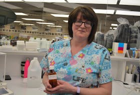 Central Pharmacy technician Michelle Bannister poses with a bottle of hand sanitizer made at the pharmacy. Nicholas Mercer/The Central Voice 