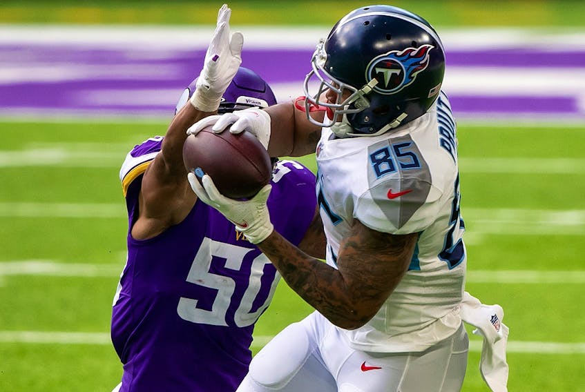 Tennessee Titans tight end MyCole Pruitt (85) catches a pass while being defended by Minnesota Vikings linebacker Eric Wilson (50) at U.S. Bank Stadium. 