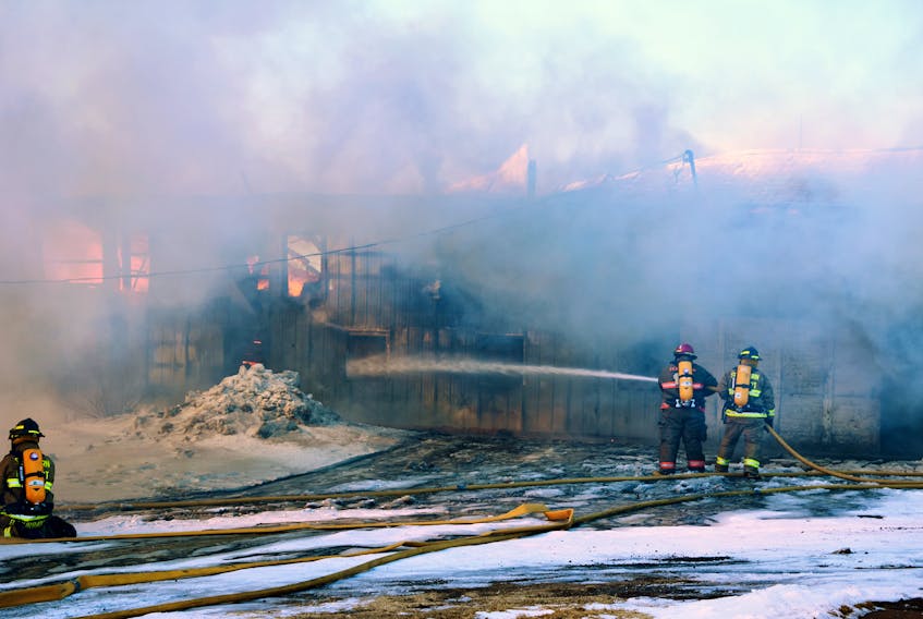 Firefighters battle a barn fire in Hardwood Hill.