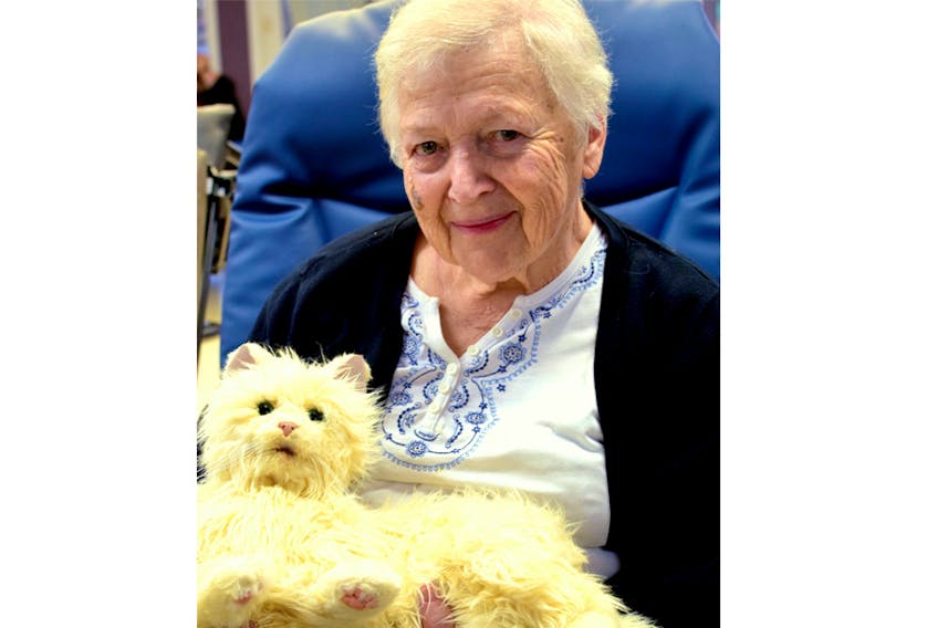 Charlotte “Honey” Rhyno, a resident at Glen Haven Manor, is pictured enjoying a new mechanical cat at Glen Haven Manor. Both the cat and dog mechanical pets are bringing great comfort to memory care residents and are being enjoyed by many residents and staff alike.